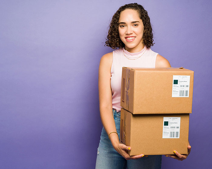 smiling young woman shipping packages